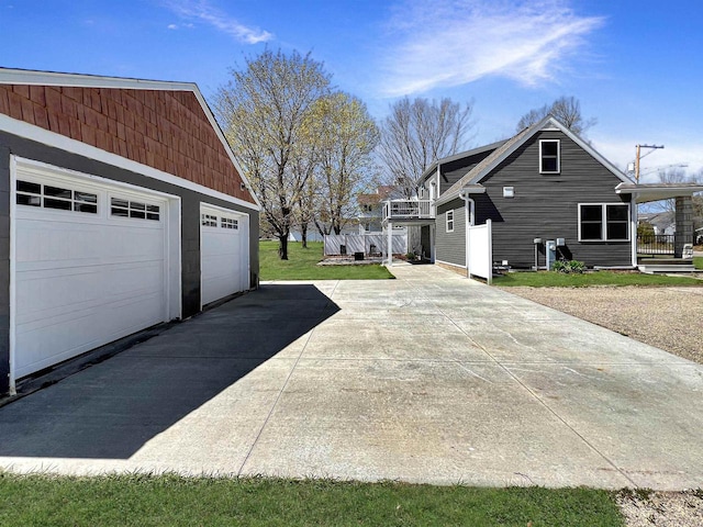 view of side of home with a lawn and a garage