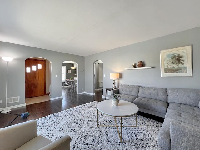 living room with dark hardwood / wood-style flooring