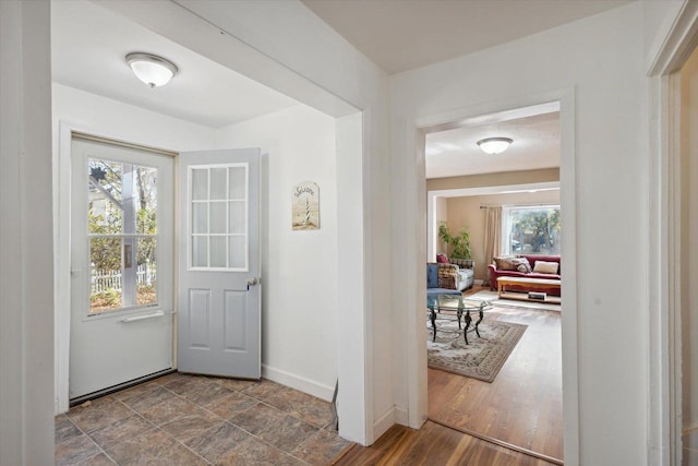 doorway with plenty of natural light and hardwood / wood-style floors