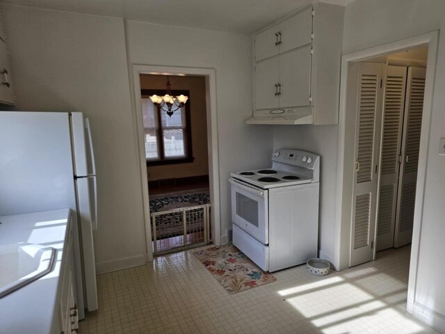 kitchen featuring white cabinets, a chandelier, and white appliances