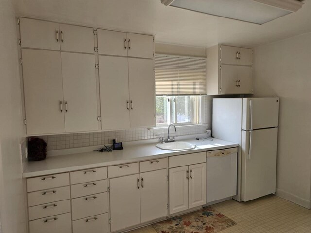 kitchen with white appliances, white cabinetry, sink, and decorative backsplash