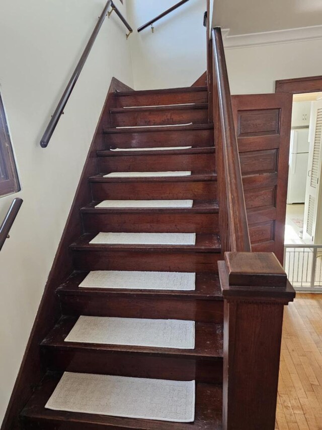 stairway featuring hardwood / wood-style floors