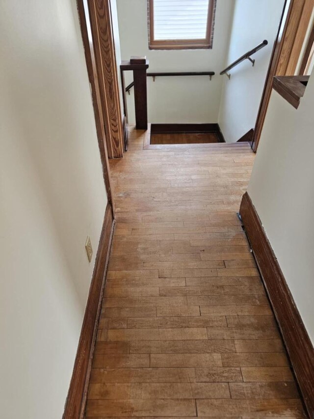 hallway with hardwood / wood-style floors