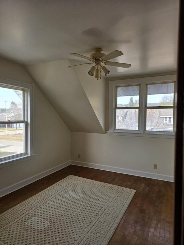 additional living space featuring lofted ceiling, ceiling fan, dark hardwood / wood-style floors, and plenty of natural light