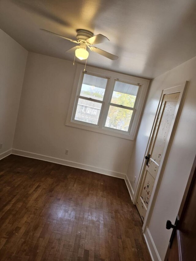 unfurnished room with dark hardwood / wood-style floors and ceiling fan