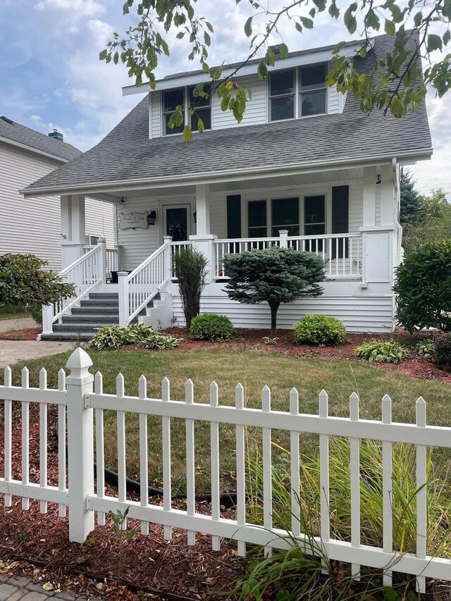 view of front of home featuring a front yard and a porch