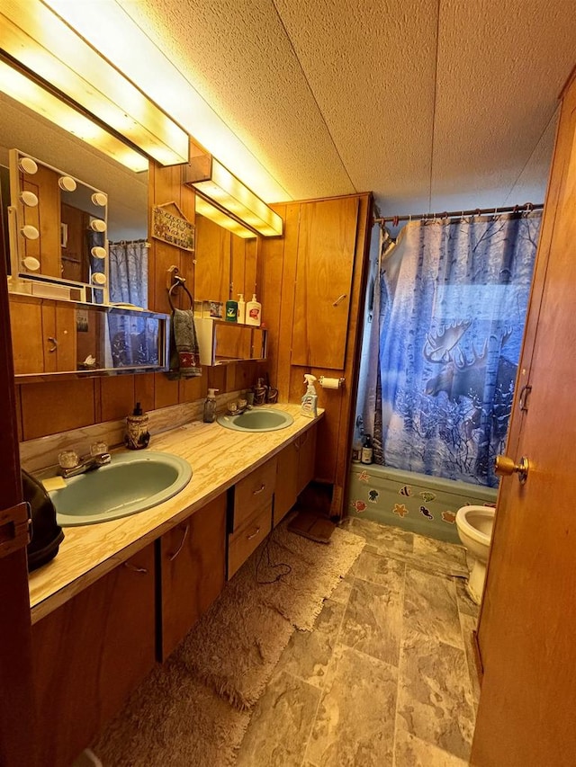 bathroom with walk in shower, wood walls, a textured ceiling, toilet, and vanity