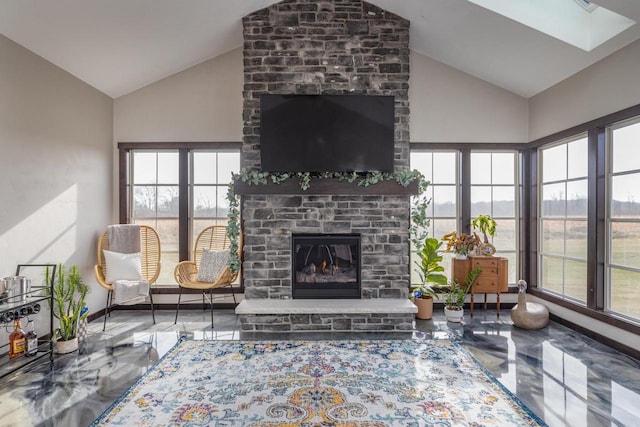 living room with a fireplace, plenty of natural light, and concrete floors