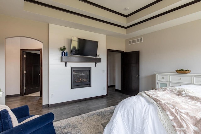 bedroom featuring dark hardwood / wood-style floors and crown molding