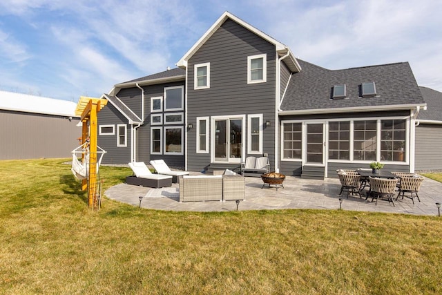 rear view of house featuring an outdoor living space with a fire pit, a yard, and a patio