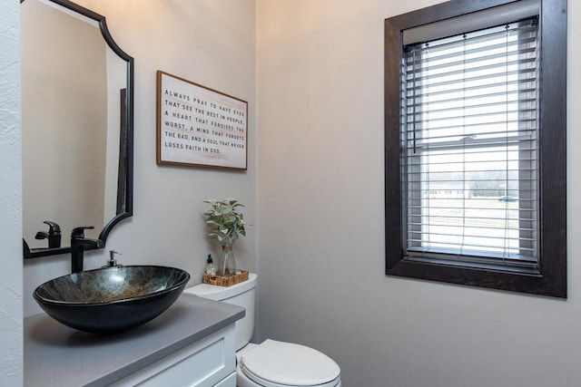 bathroom featuring vanity and toilet