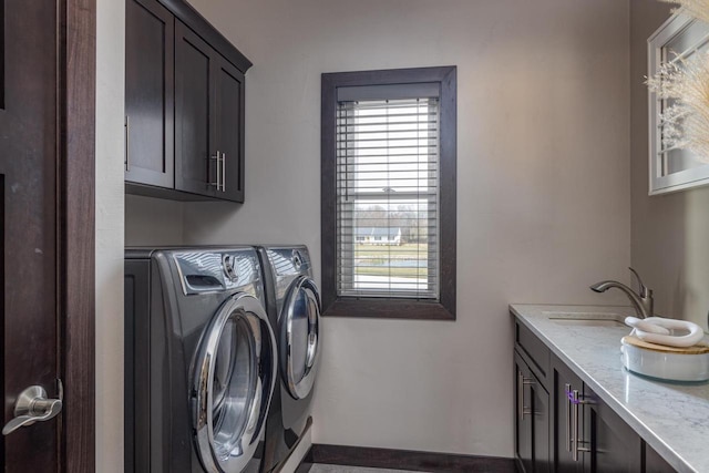 washroom with washer and clothes dryer, cabinets, and sink