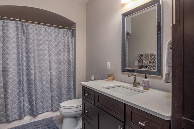 bathroom featuring toilet, vanity, tile patterned floors, and curtained shower