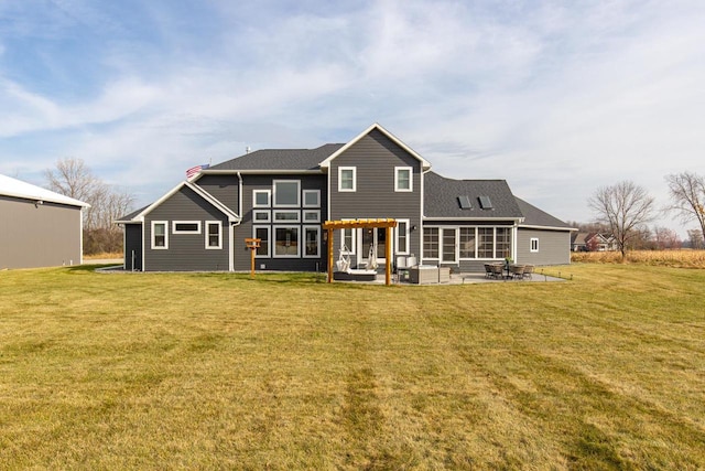 rear view of property featuring a lawn and a patio area