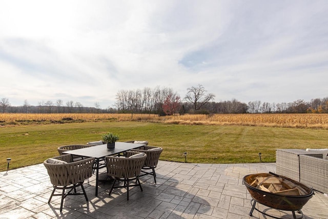 view of patio featuring a rural view and a fire pit