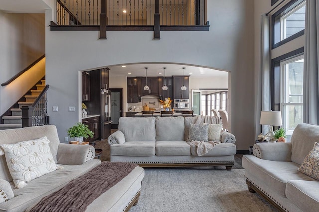 living room featuring a towering ceiling