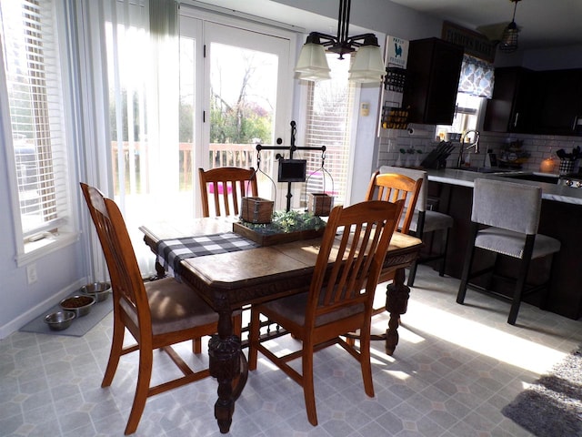 dining room with sink and an inviting chandelier