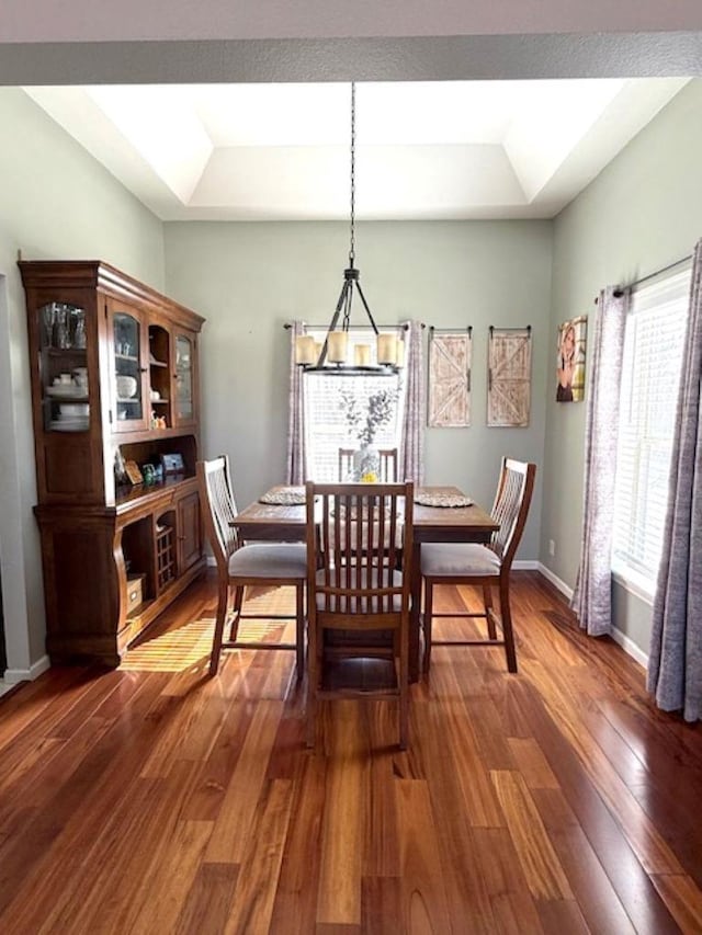 N4266 Cherokee Ct, Markesan, WI 53946 - dining space with a raised ceiling, wood finished floors, a chandelier, and baseboards