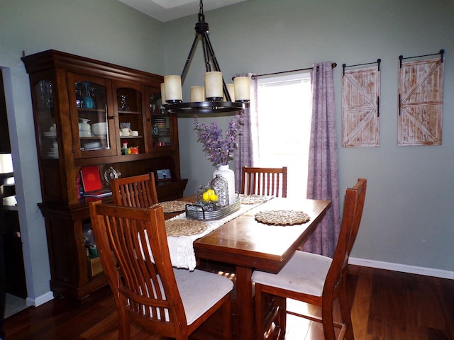 dining room featuring a notable chandelier and dark hardwood / wood-style flooring