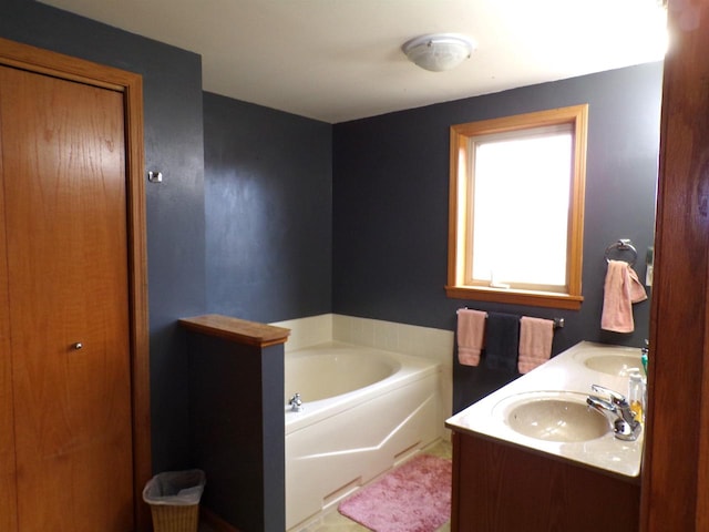 bathroom featuring vanity and a tub