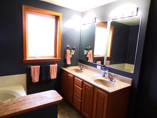 bathroom with vanity and a tub to relax in