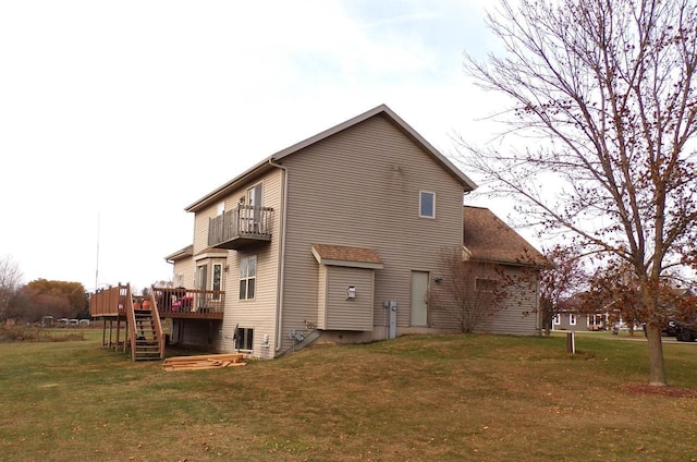 N4266 Cherokee Ct, Markesan, WI 53946 - rear view of house featuring a balcony, a lawn, stairs, a wooden deck, and central AC