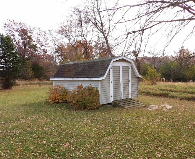 view of outdoor structure featuring a lawn