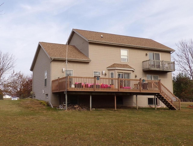 rear view of property featuring a wooden deck and a yard