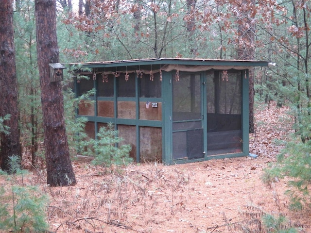 view of outdoor structure with a sunroom