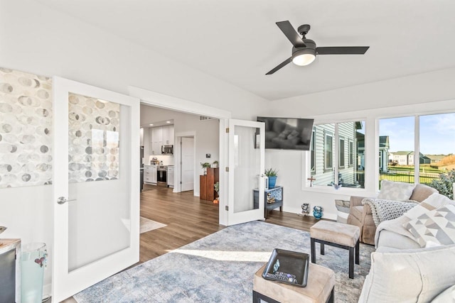 living room featuring hardwood / wood-style floors and ceiling fan