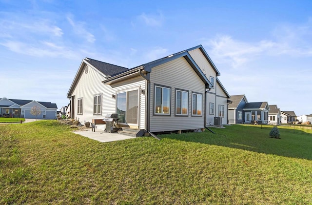 back of house with a patio, a yard, and central AC unit