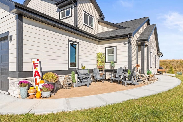 view of side of property featuring a patio area