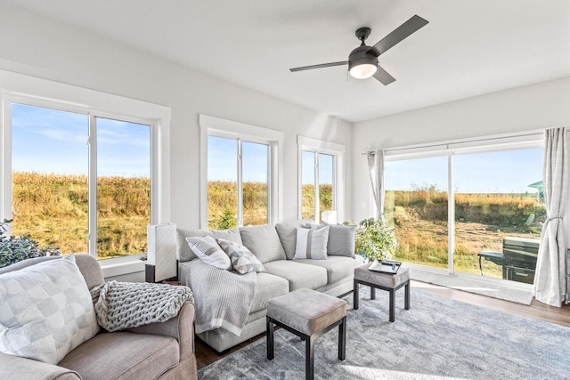 sunroom / solarium featuring ceiling fan