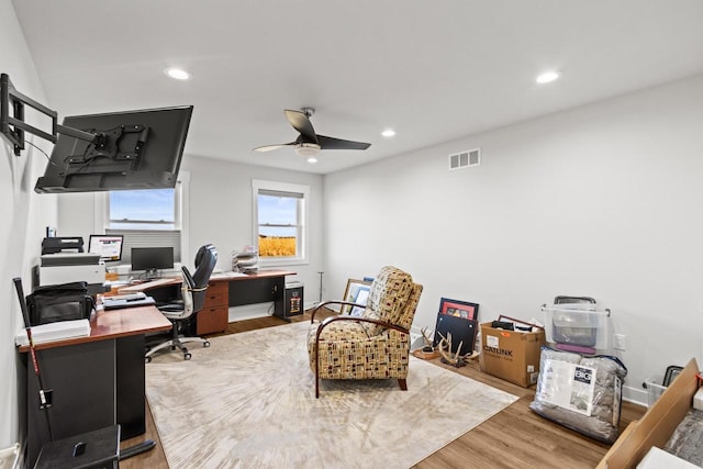 home office with hardwood / wood-style floors and ceiling fan