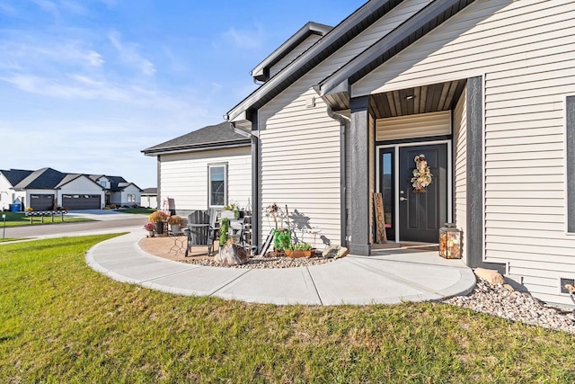 doorway to property featuring a yard