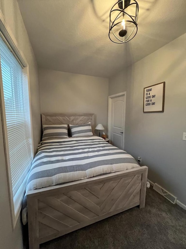 bedroom with dark colored carpet