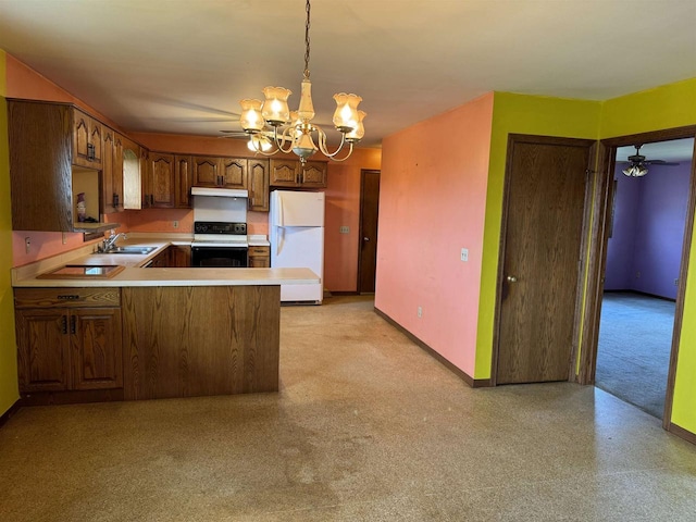 kitchen featuring white appliances, sink, ceiling fan with notable chandelier, kitchen peninsula, and decorative light fixtures