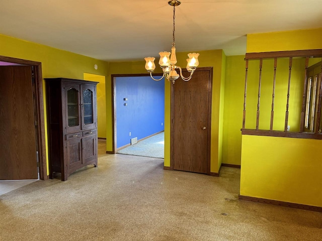 unfurnished dining area featuring a chandelier