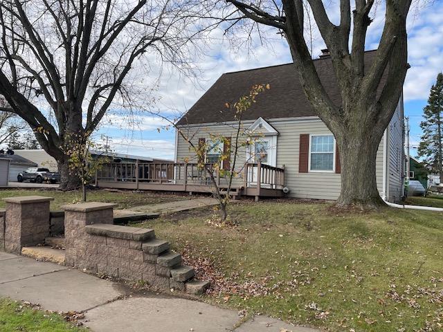 view of front facade with a front yard and a deck