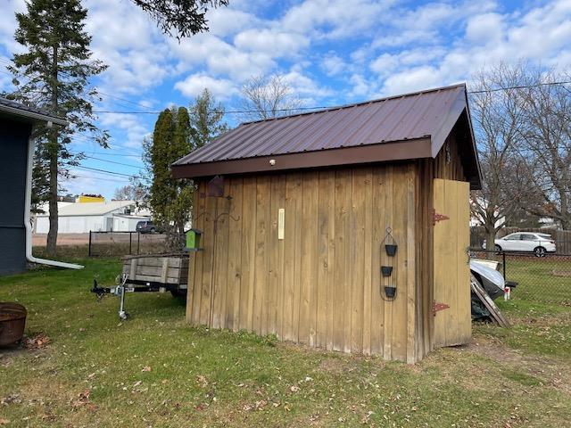 view of outbuilding with a lawn