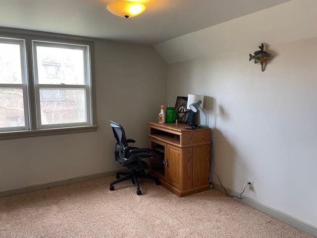 office space with light carpet and lofted ceiling