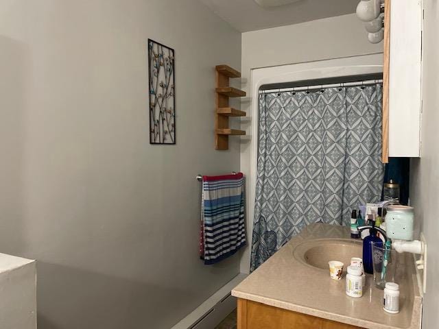 bathroom featuring walk in shower and vanity