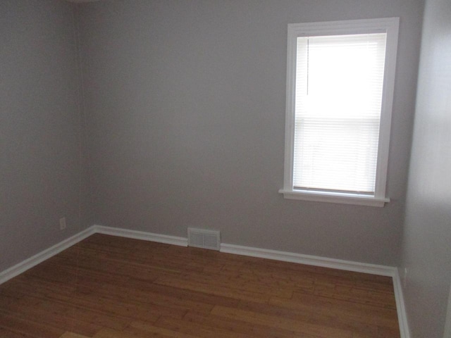 unfurnished room featuring dark wood-type flooring