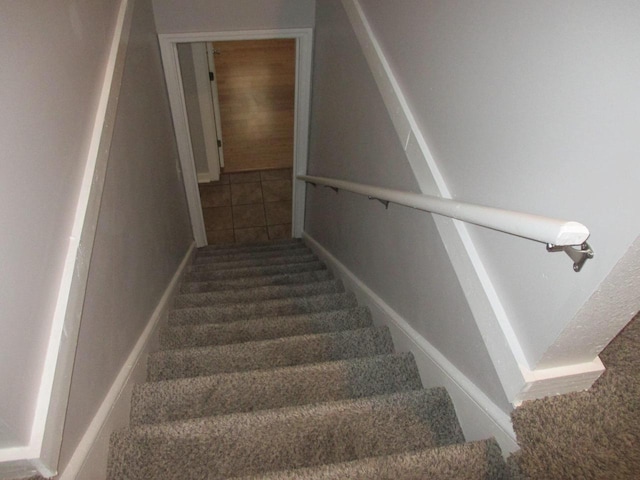 staircase with tile patterned floors