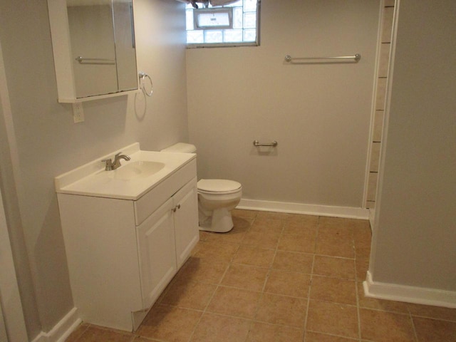 bathroom featuring vanity, toilet, and tile patterned flooring