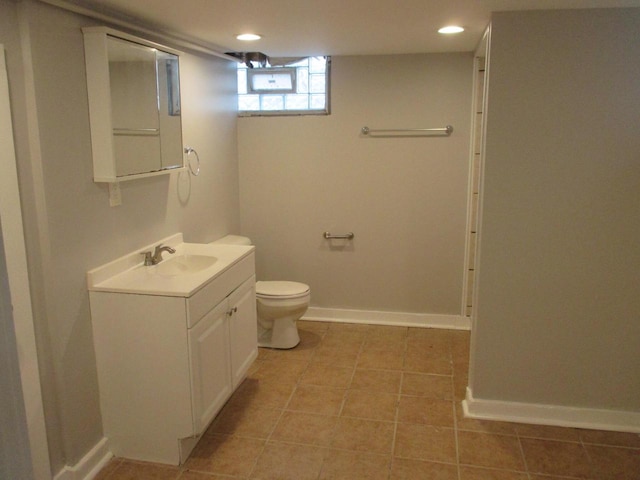 bathroom with vanity, toilet, and tile patterned floors