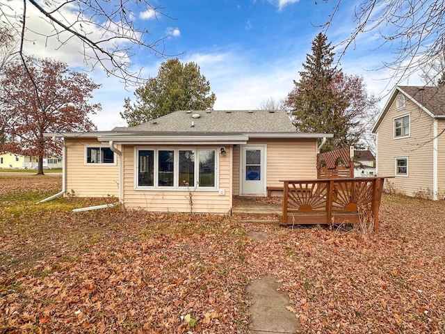 back of property with a wooden deck