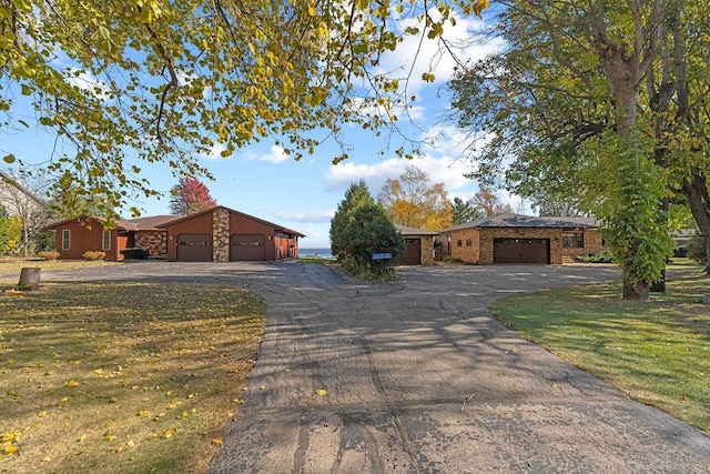 ranch-style home featuring a garage and a front yard