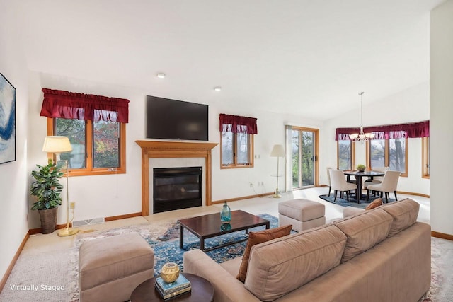 living room with light colored carpet, lofted ceiling, and a notable chandelier