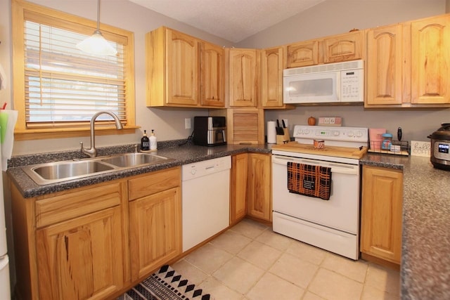 kitchen featuring decorative light fixtures, light tile patterned floors, sink, white appliances, and lofted ceiling